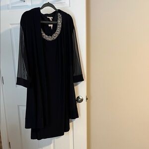 Elegant Black Women's Dress with Embellished Neckline and Jacket.
